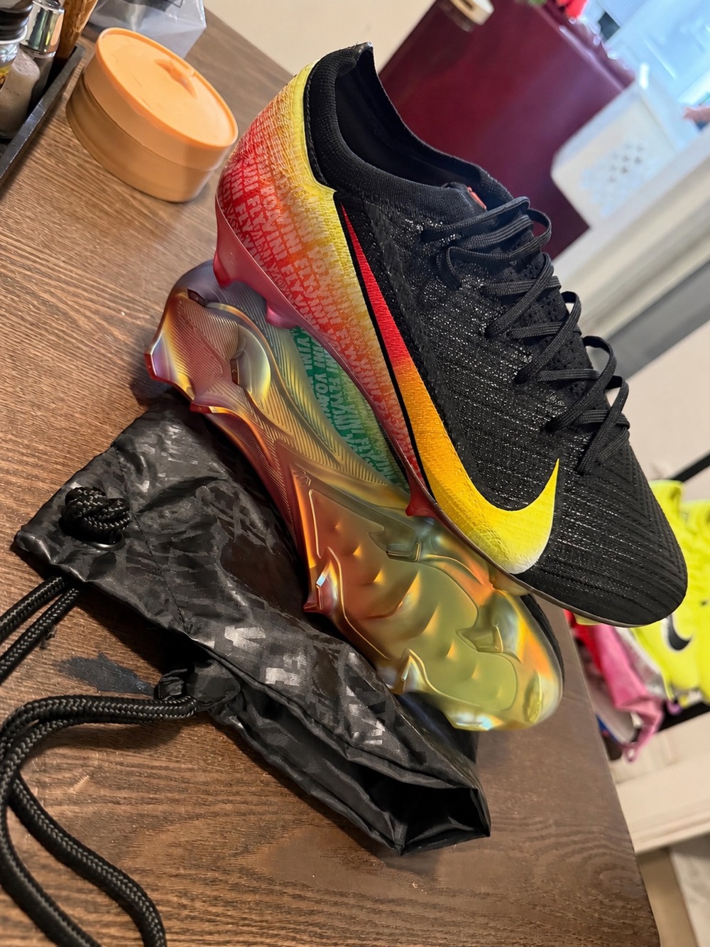 Nike Black Soccer Cleats with Yellow-to-Red Gradient and Iridescent Sole